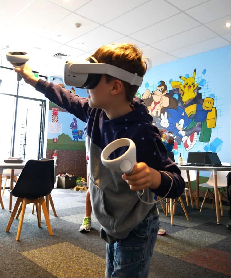 Pixel Party — a customer playing a VR game in front of the finished mural