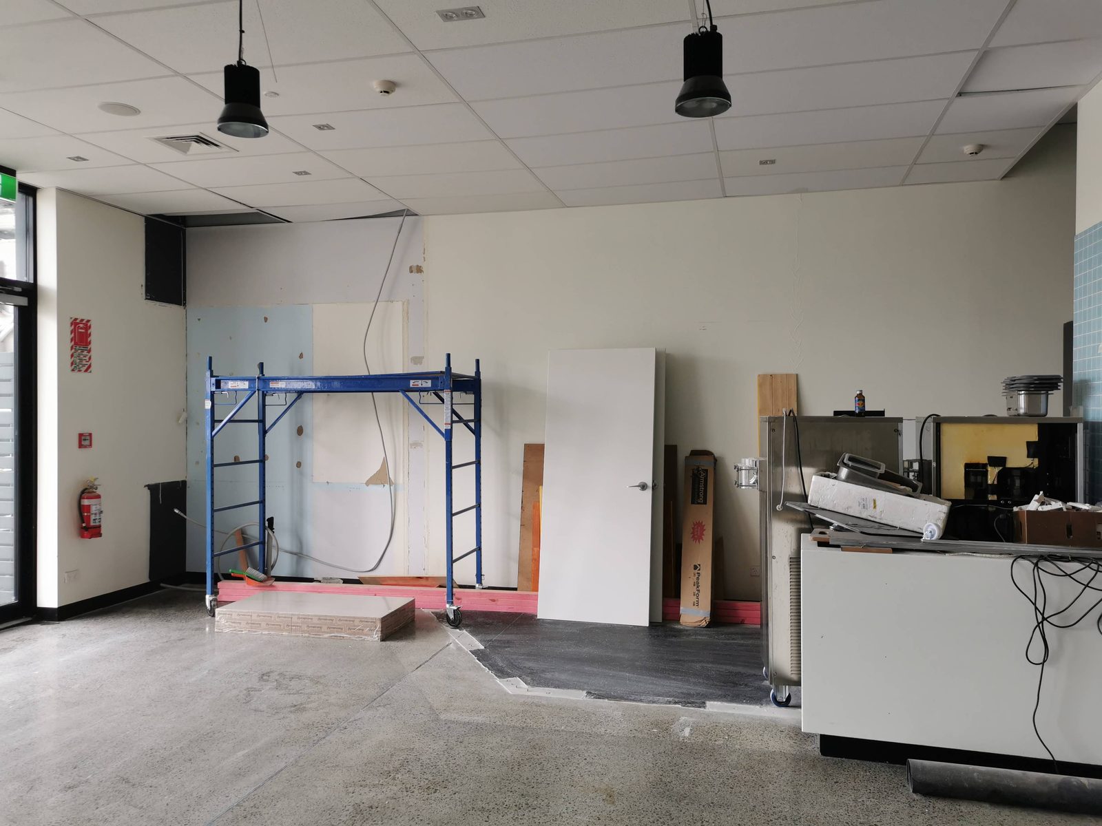 Pixel Party — empty room corner with fit-out materials, pre-mural
