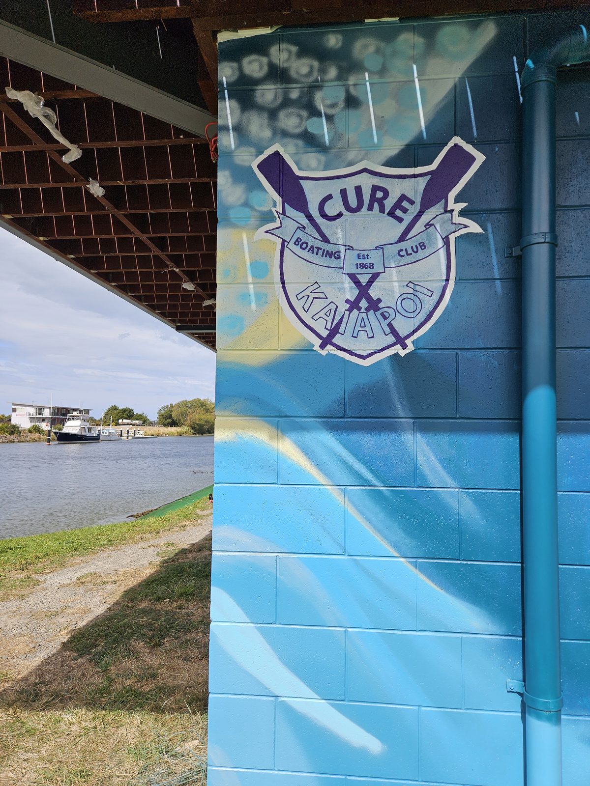 Pulling Together mural in progress — early detail of the bird emblem and blue gradient corner