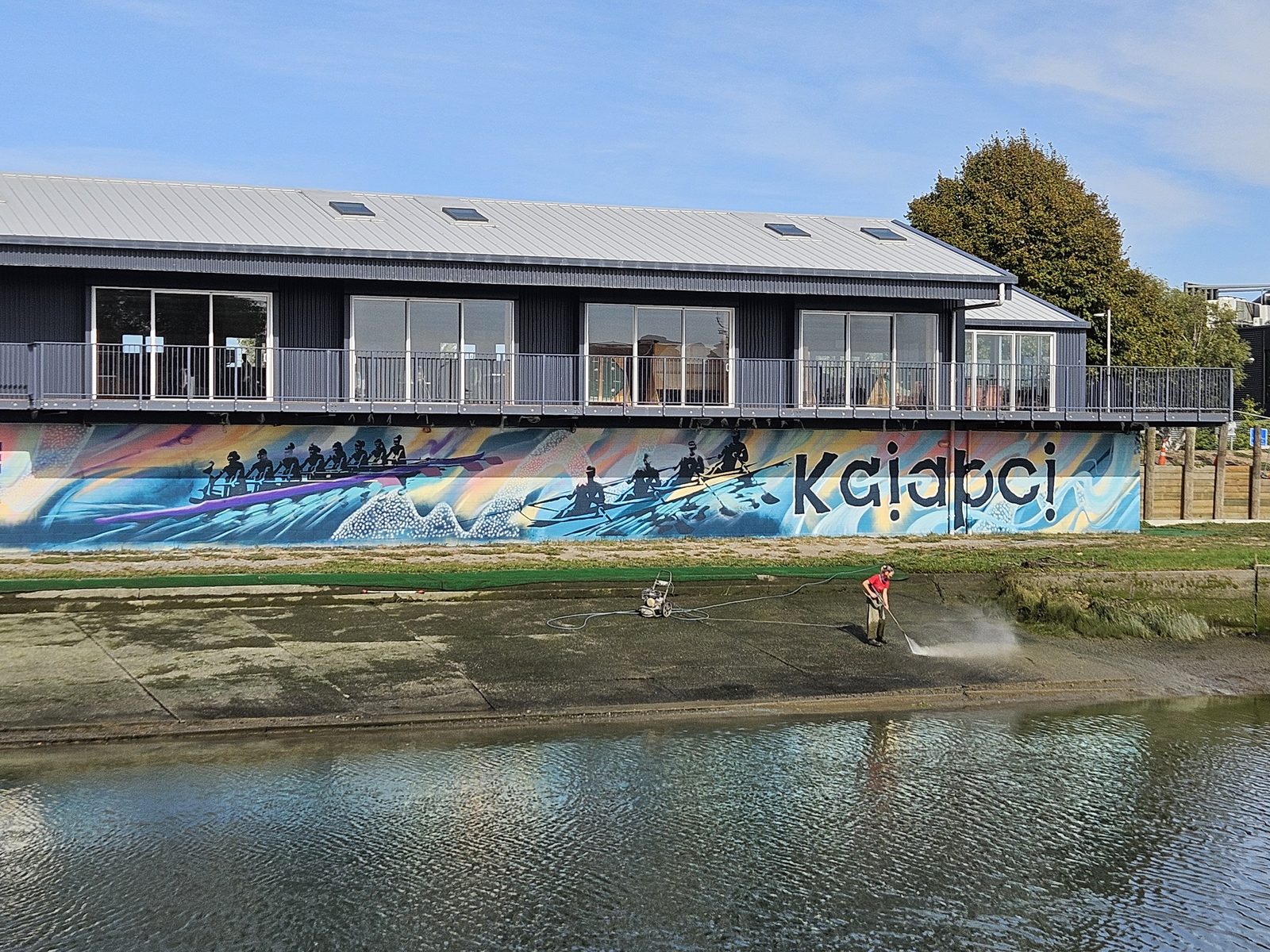 Pulling Together mural — daytime view of the clubrooms with the finished mural along the base