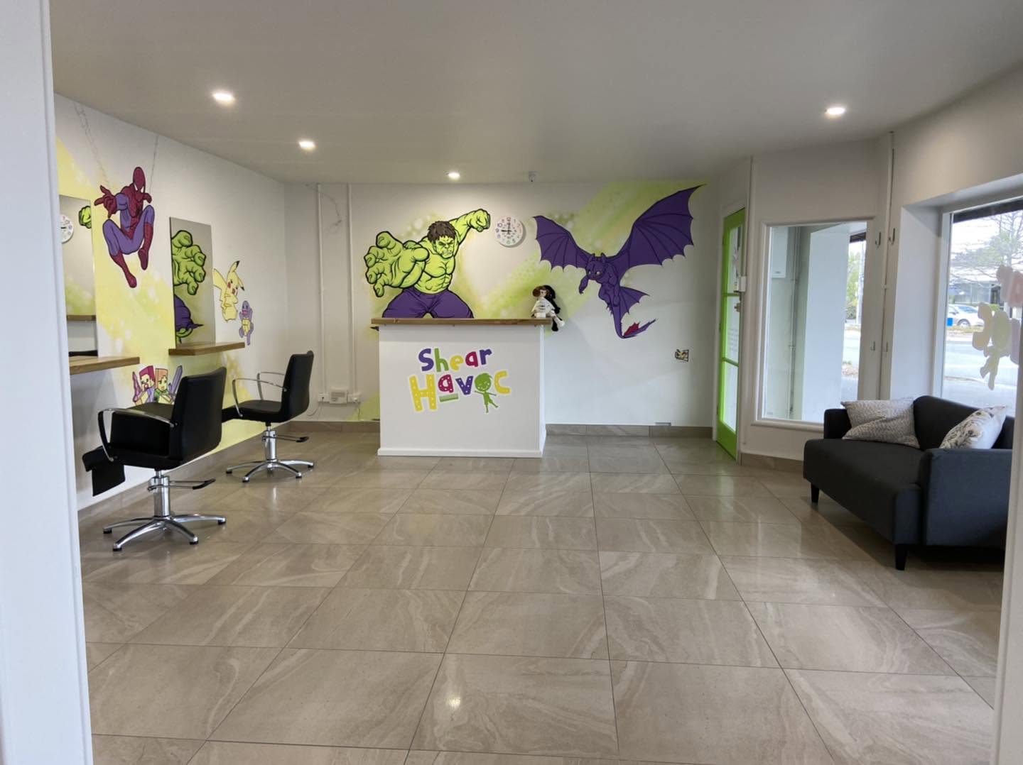 Shear Havoc mural — salon seating area with the Hulk and purple dragon characters