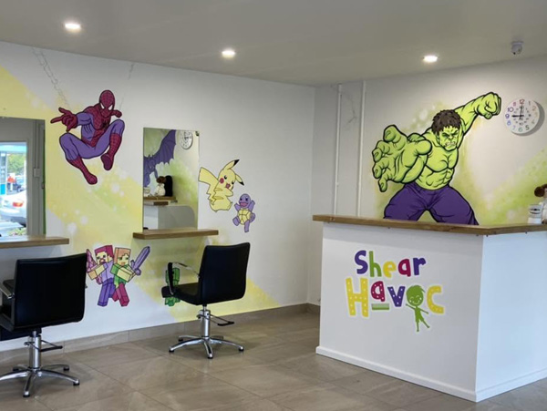 Shear Havoc mural — Spider-Man, Hulk and Pikachu characters painted across the kids' salon walls and reception desk