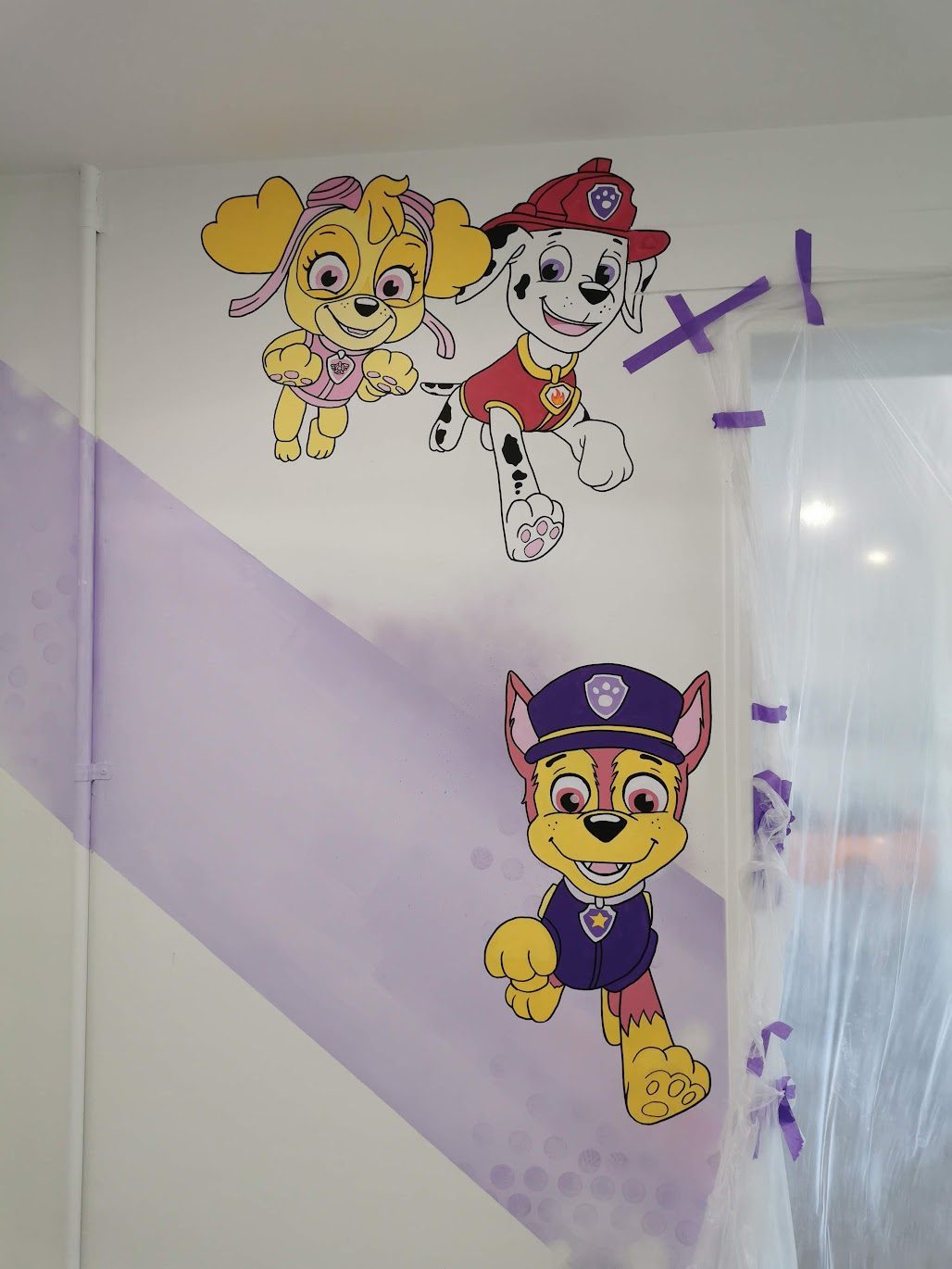 Shear Havoc mural detail — Paw Patrol characters painted in the salon corner
