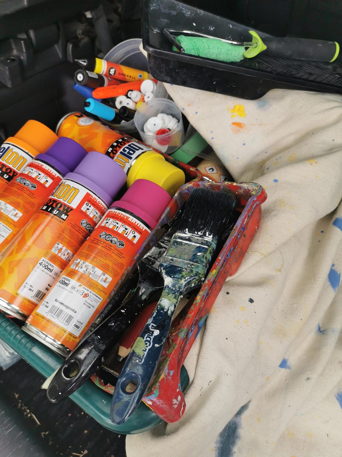 You Rock mural — paint cans and spray equipment used for the gym mural