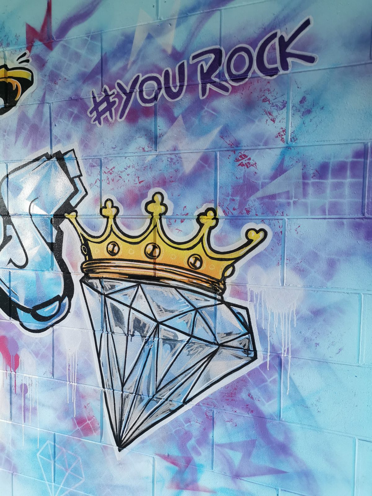 You Rock mural detail — the '#YouRock' tag with diamond and crown graphic