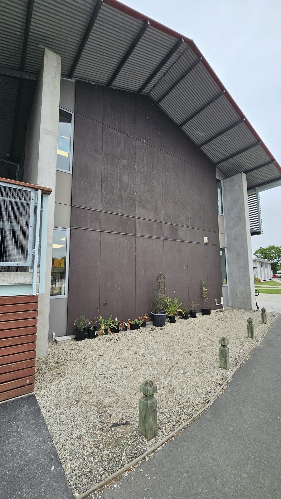 Around The Tree — plain brown wall under the school's covered walkway before the mural