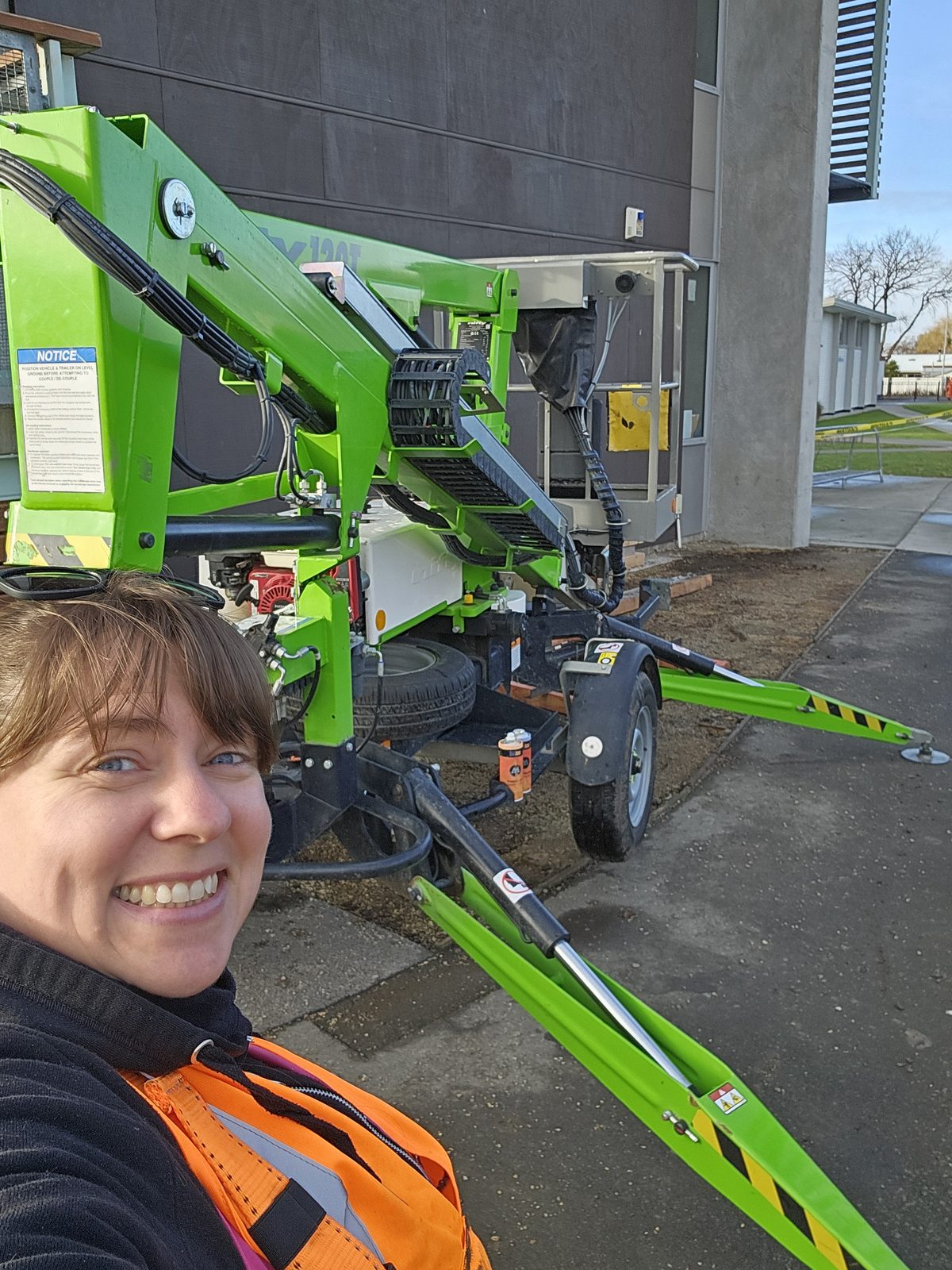 Around The Tree — Mel on a cherry picker ready to paint the upper sections of the wall