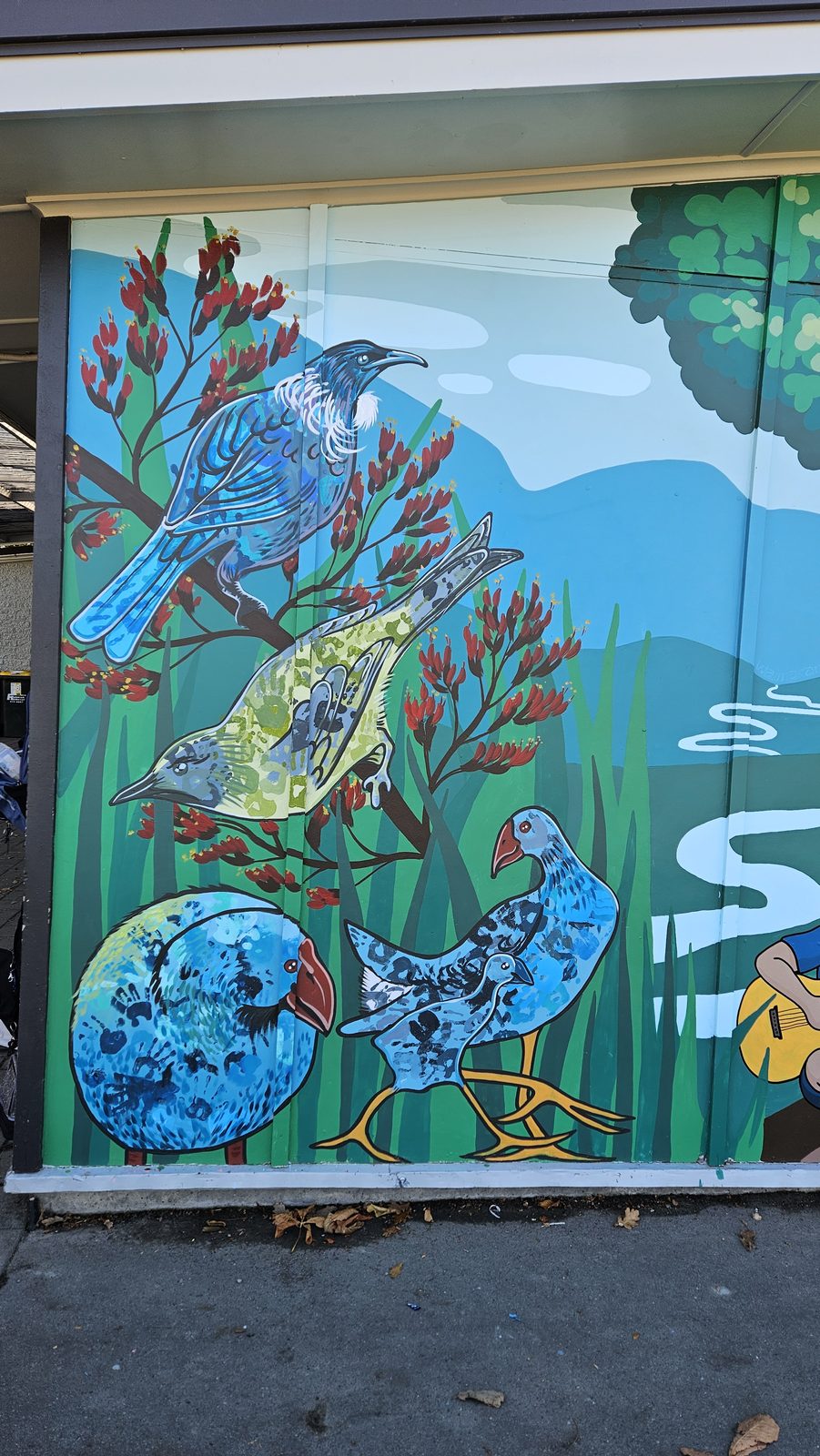 Flock Together mural in progress — birds and tree details taking shape on the wall
