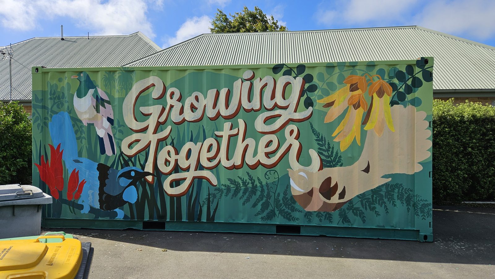Growing Together mural — finished 'Growing Together' lettering with native bird and flowers