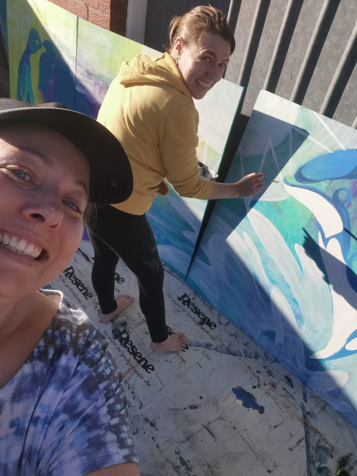Natures Playground mural in progress — applying stencil detail to a large panel