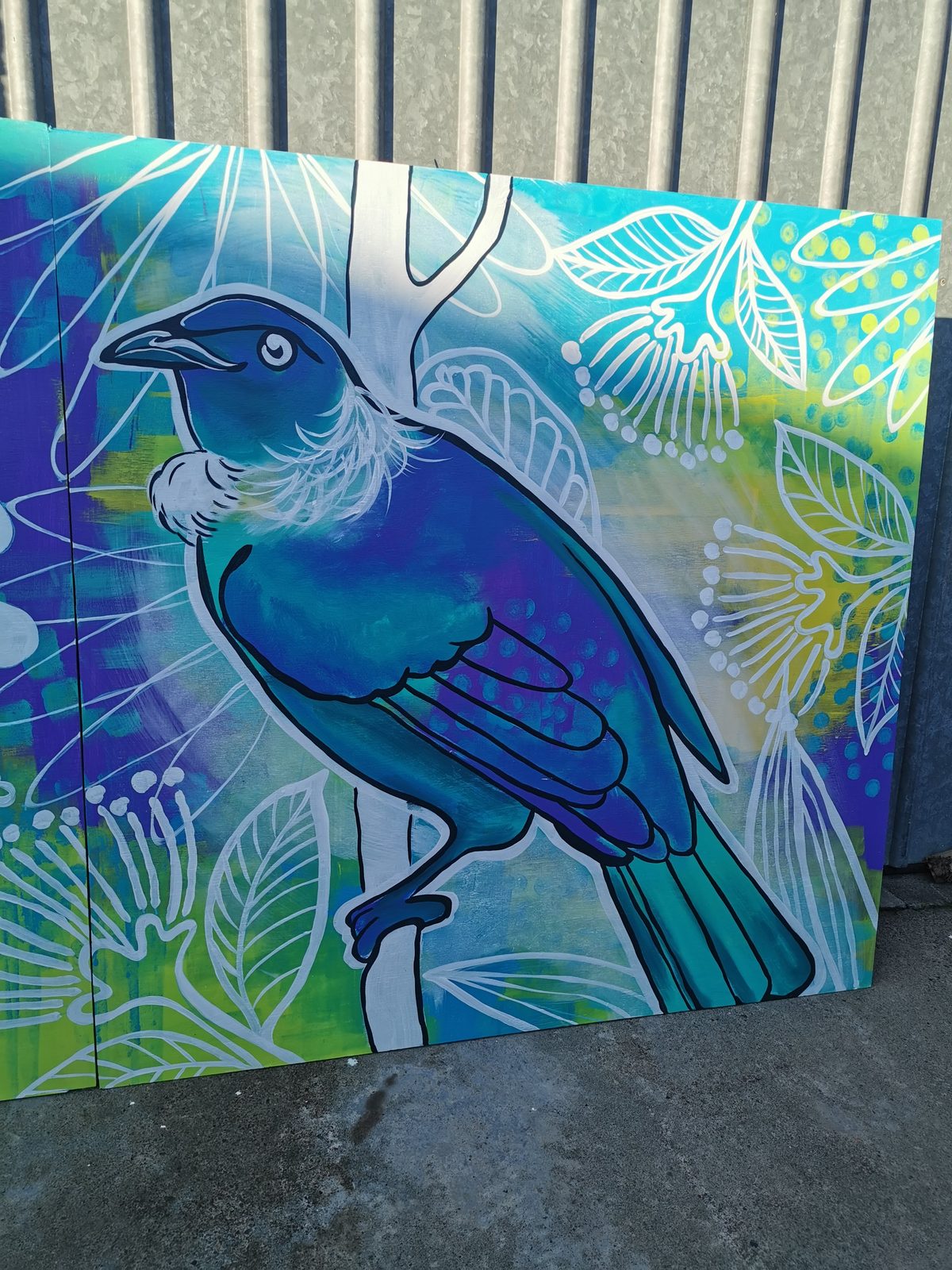Natures Playground mural detail — a tūī painted among ferns and leaves