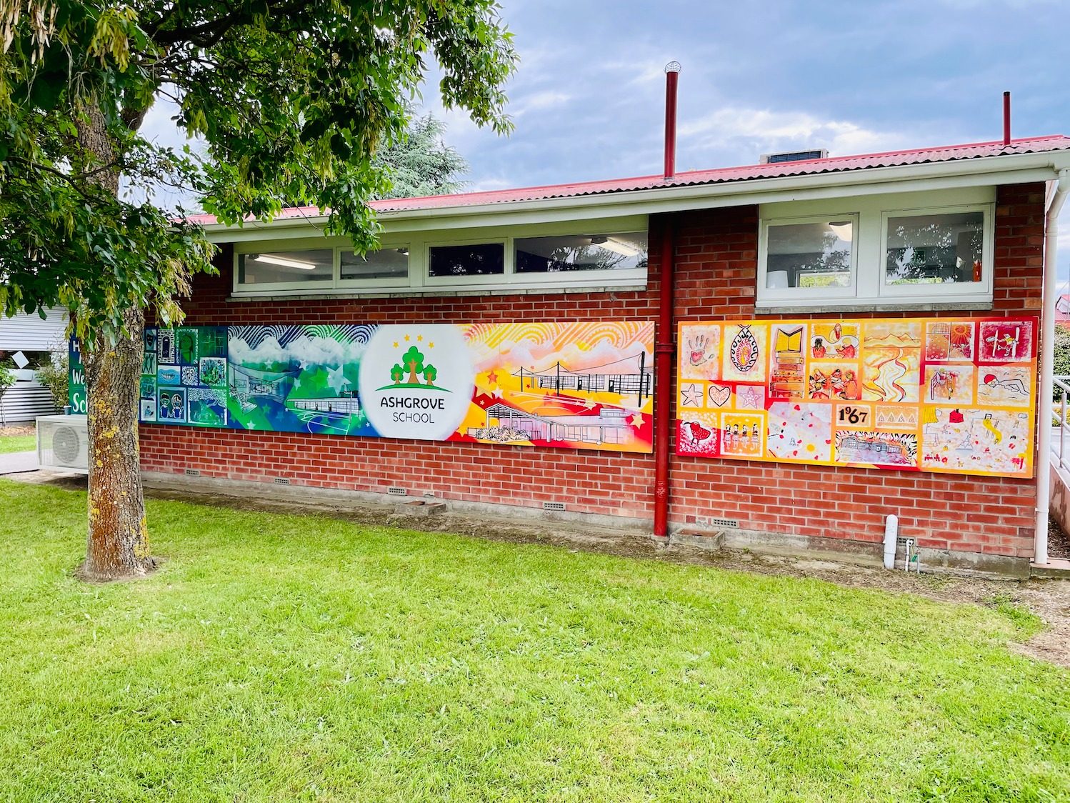 Our Stars mural — finished panels along the school wall in daylight