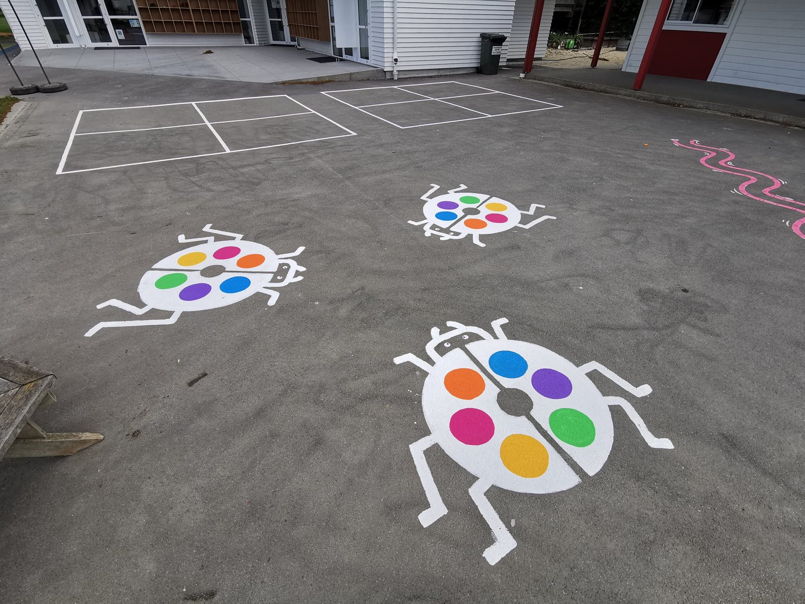 Playtime Bugs — colour-matching ladybird games painted on the schoolyard asphalt