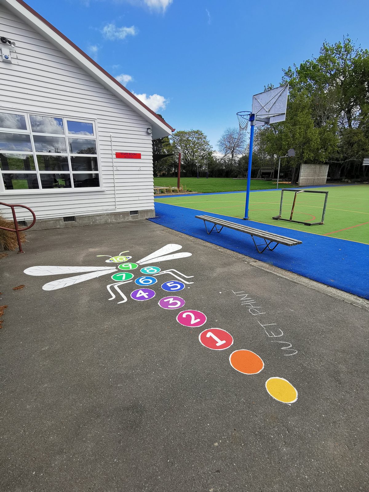 Playtime Bugs — a colour-matching caterpillar game near the school's sports court