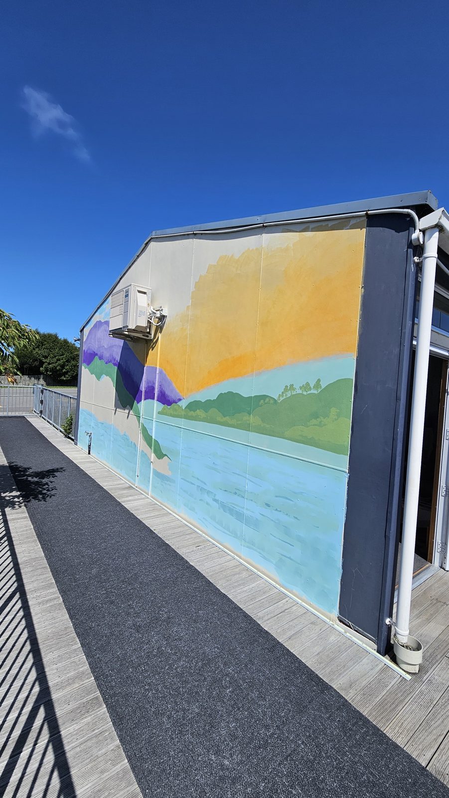 Turangawaewae mural — finished mountain landscape wrapping around the building's corner