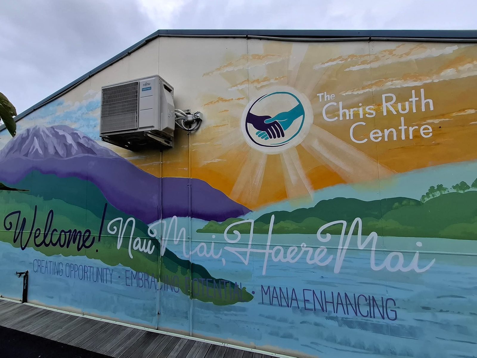 Turangawaewae mural — finished view with the Chris Ruth Centre logo and 'Welcome, Nau Mai Haere Mai' lettering