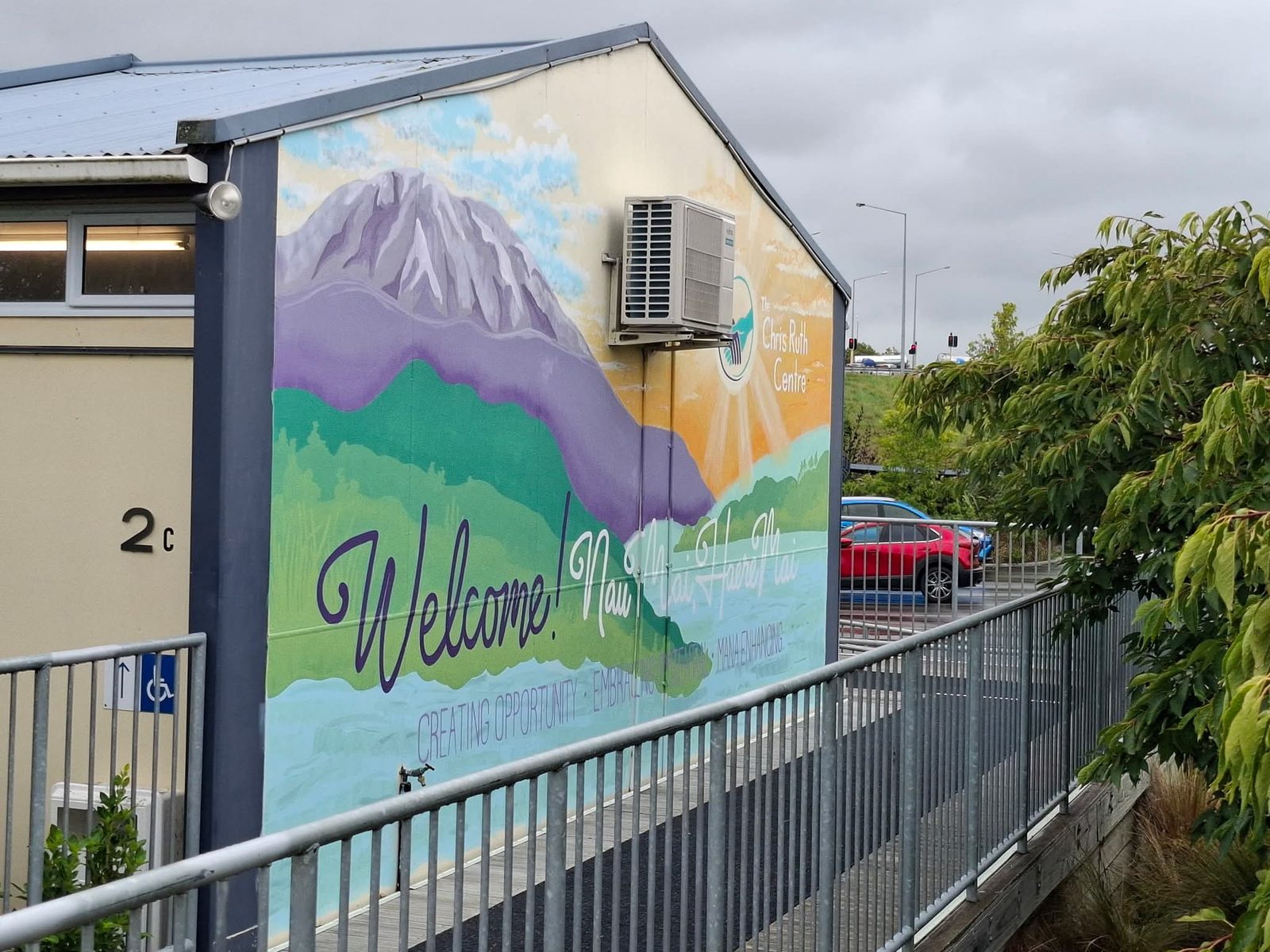 Turangawaewae mural — finished mountain landscape and welcome lettering viewed from another angle