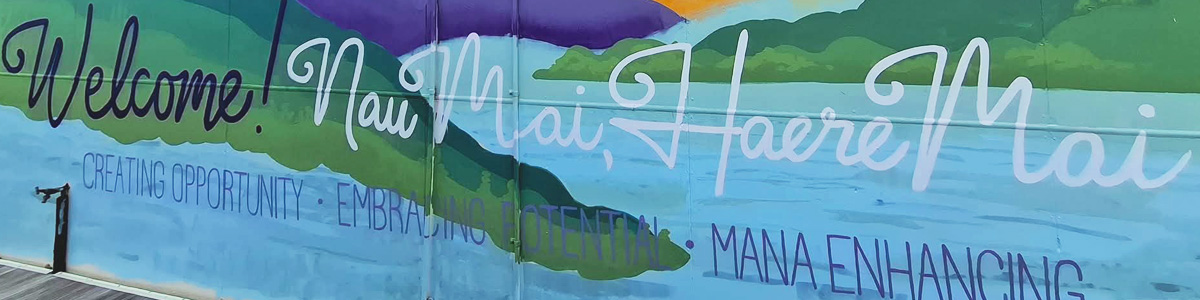 Turangawaewae mural — 'Welcome! Nau mai, Haere mai' lettering over a mountain and lake landscape, with the words 'Creating opportunity, embracing potential, mana enhancing'