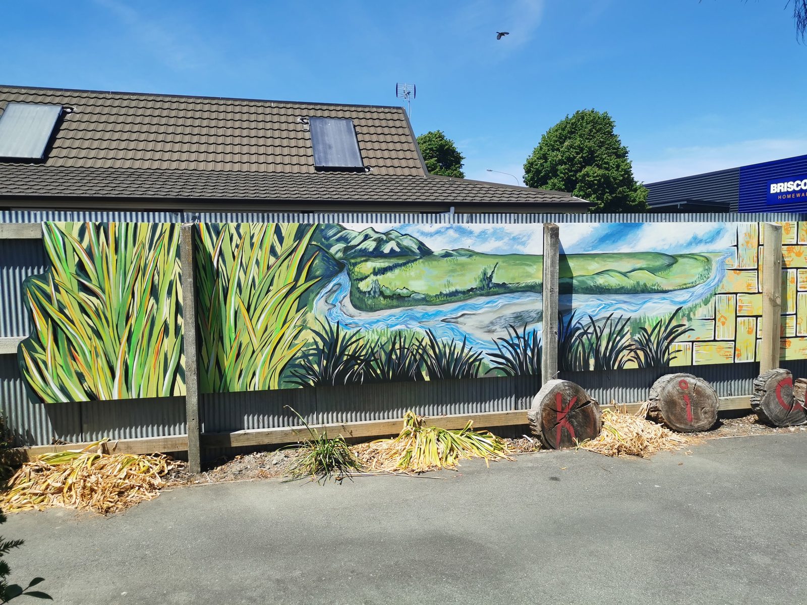 Weaving Together mural — wide view of the finished fence panels