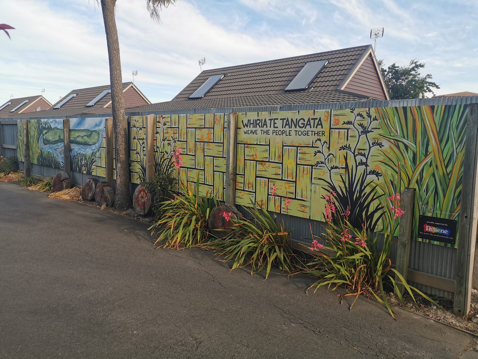 Weaving Together mural — finished fence panels viewed from the footpath