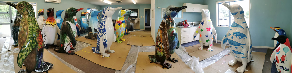 Birds of a Feather — line-up of penguin sculptures mid-production in the Wild In Art painting studio, ahead of the Pop-up Penguins trail