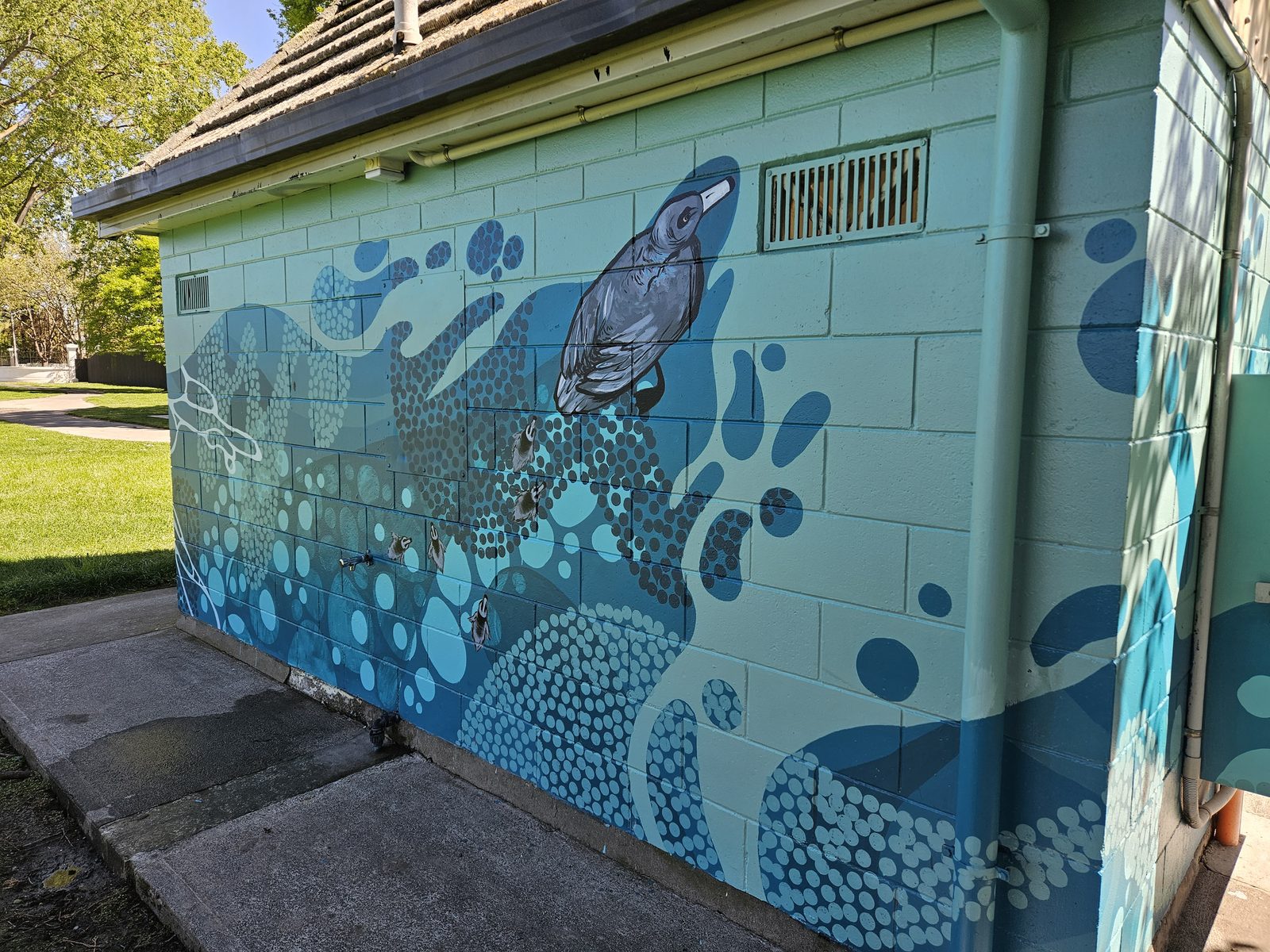 Flowing With Whio mural — side view of the finished building and design