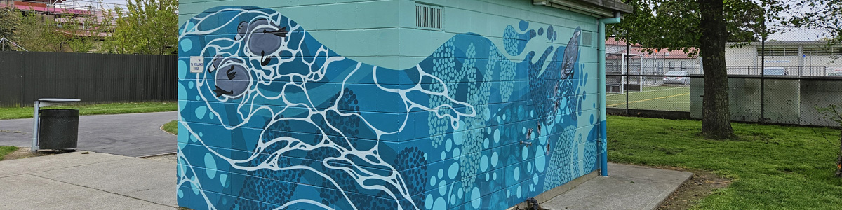 Flowing With Whio mural — full view of the abstract whio design wrapping around the Dudley Park toilet block
