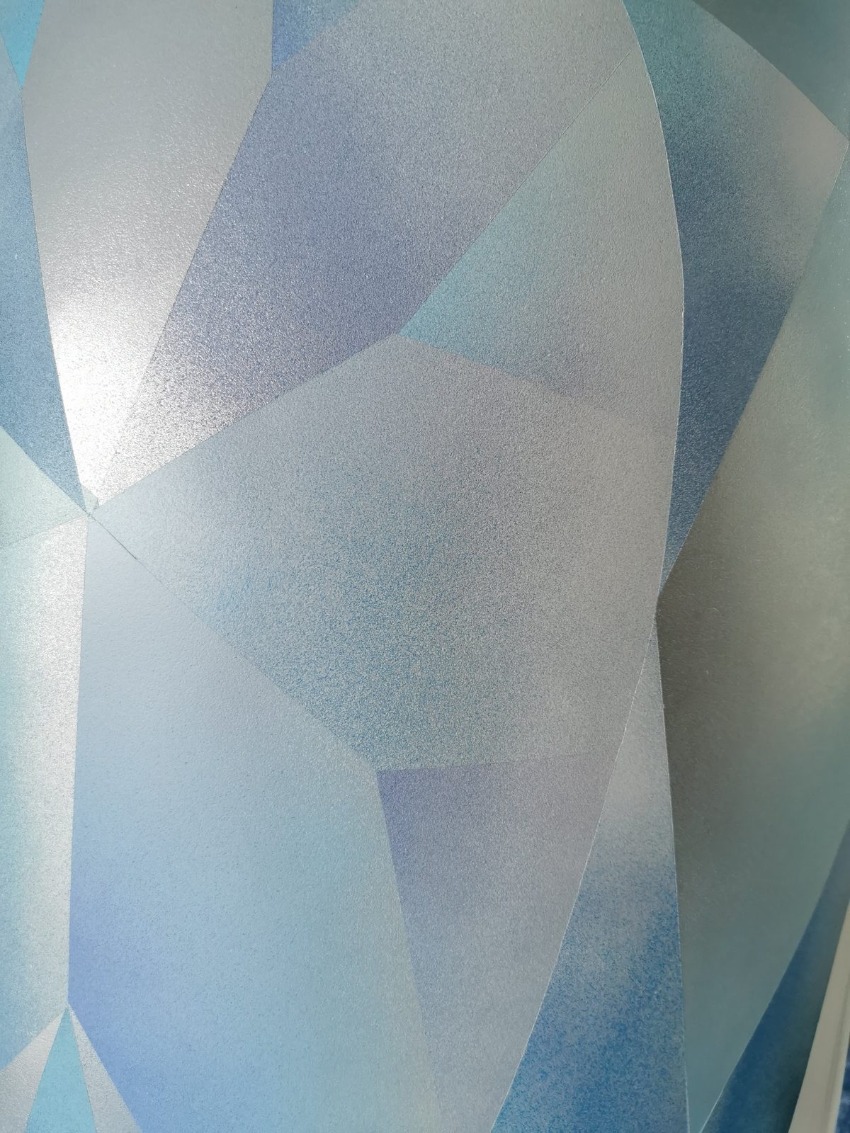 Ice sculpture in progress — early blue facet pattern being painted onto the sculpture