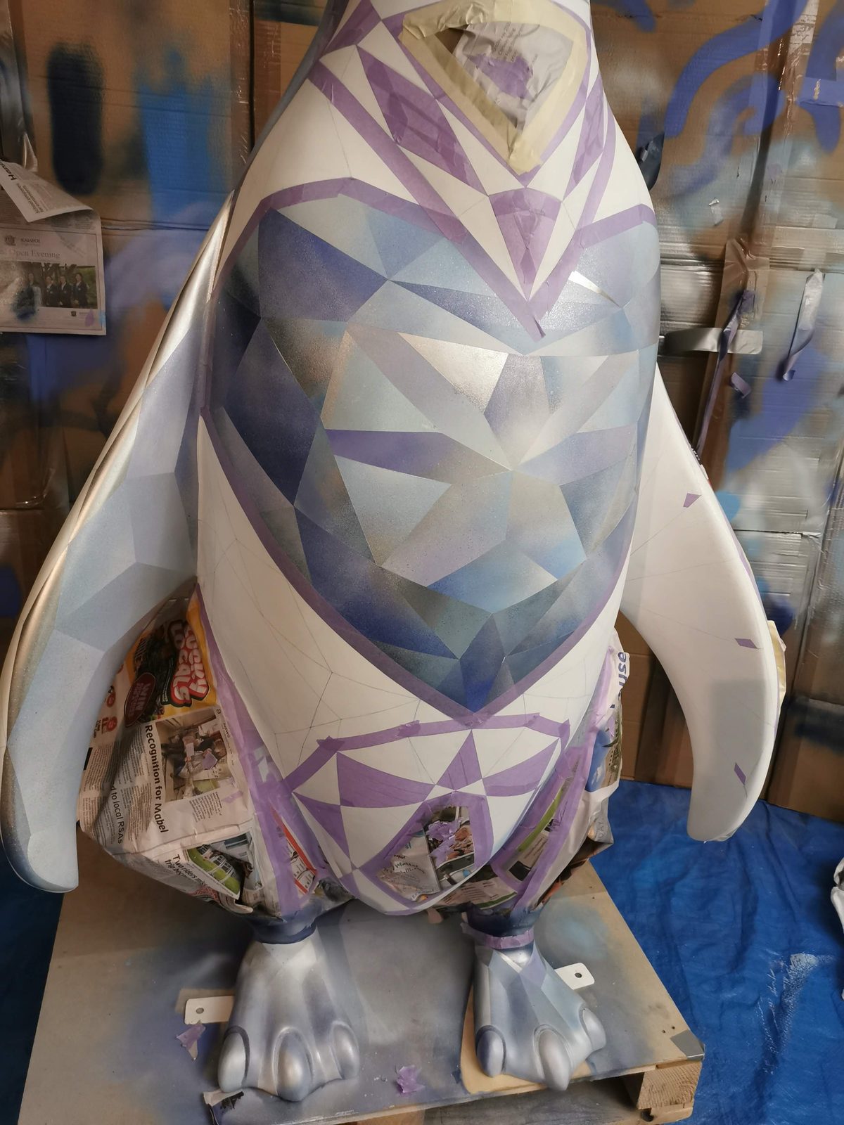 Ice sculpture in progress — blue and white diamond facets partially painted