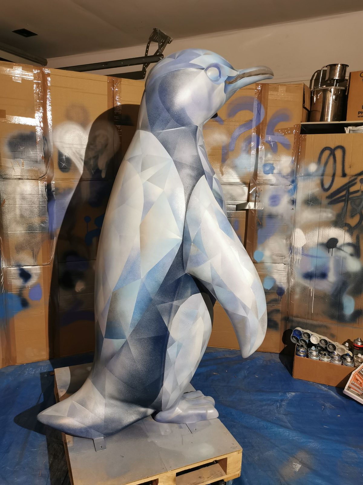 Ice sculpture in progress — faceted blue pattern nearing completion