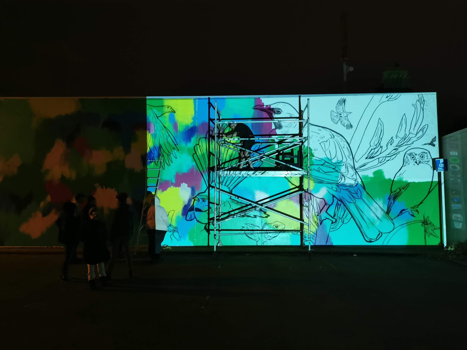 In Our Hands mural in progress — projecting the design outline onto the wall at night