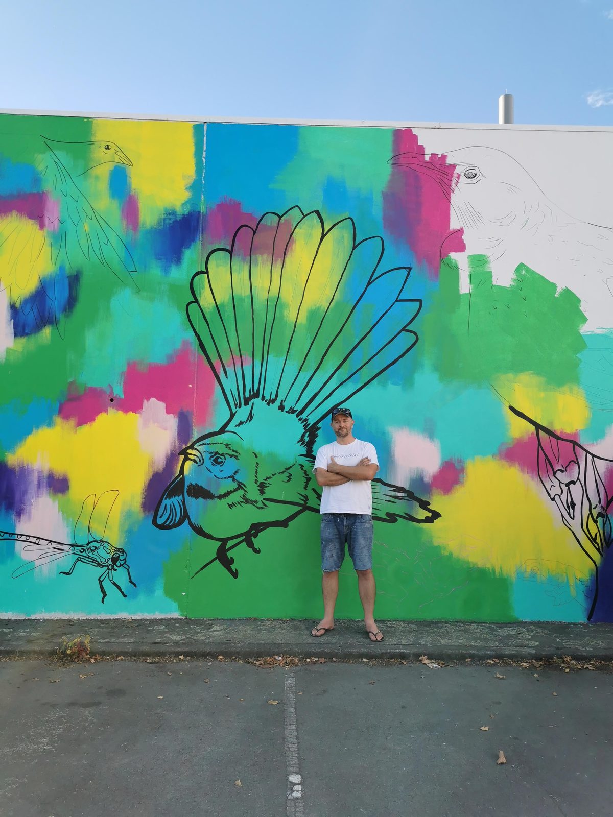In Our Hands mural in progress — standing back to review the colourful abstract design