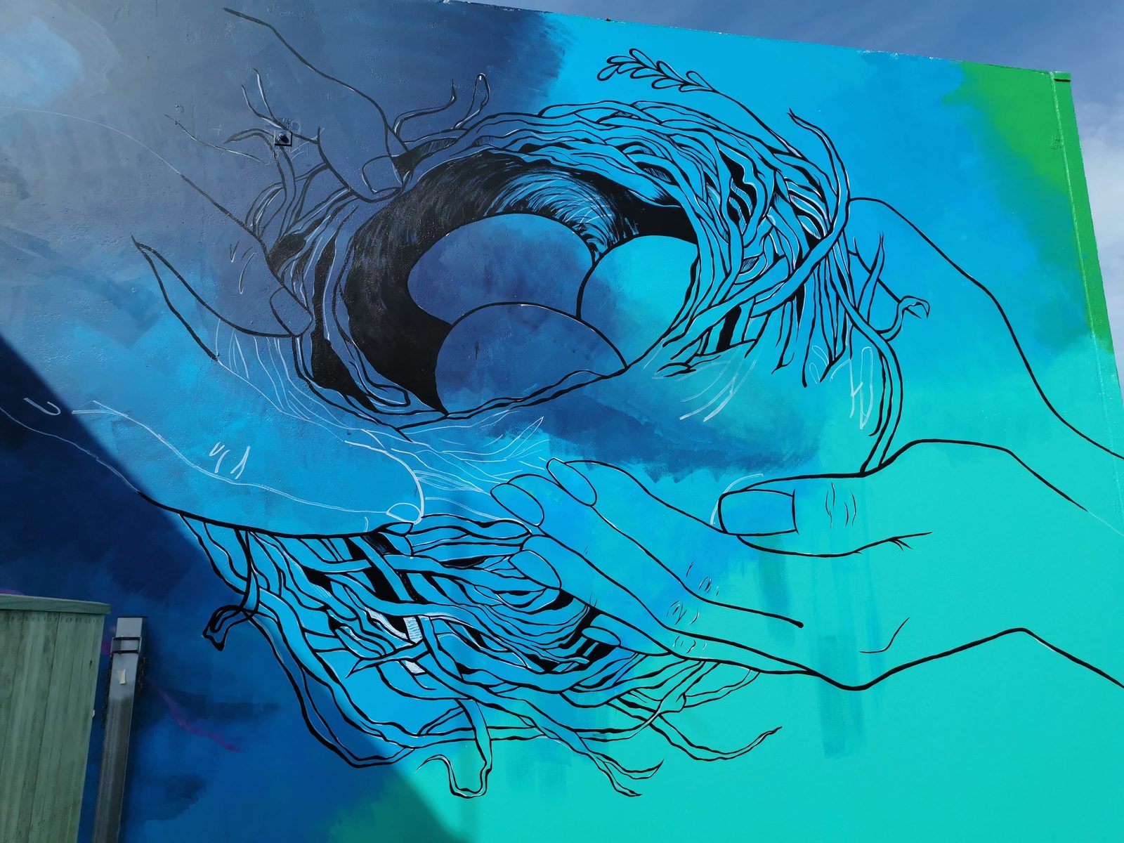 In Our Hands mural detail — the woven nest of eggs representing the hands of Ranginui and Papatūānuku
