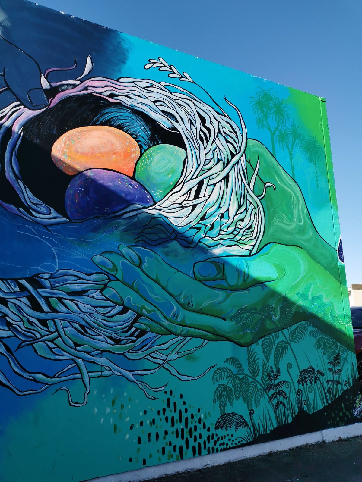 In Our Hands mural detail — close-up of the Haast eagle's dark blue wing