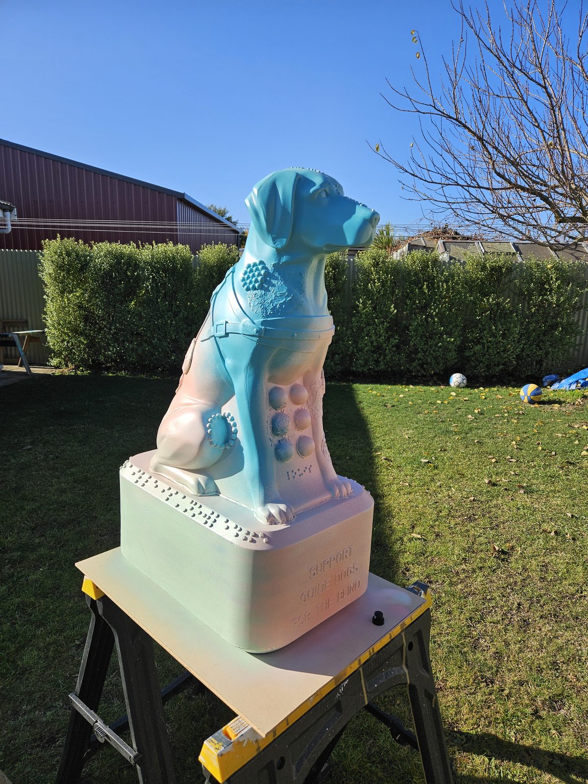 Louis Braille sculpture — blank white sculpture displayed outdoors on a stand