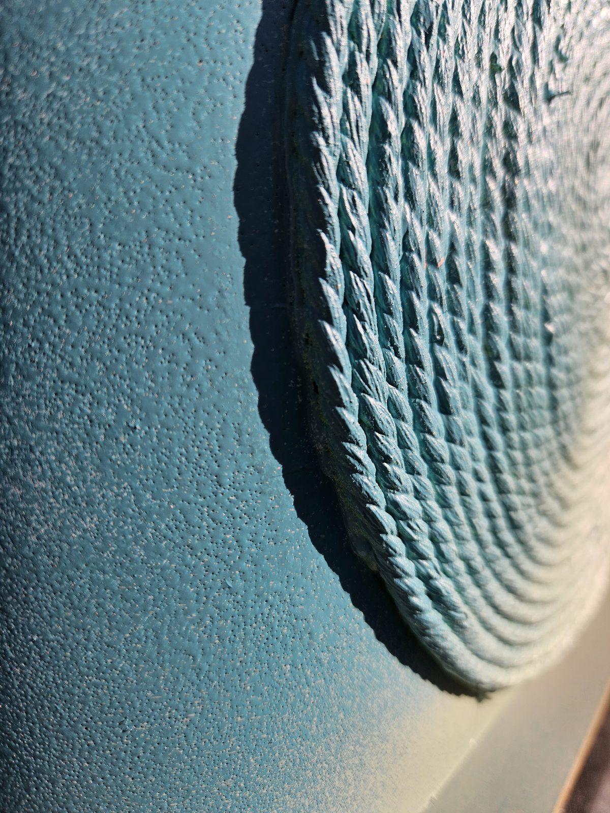 Louis Braille sculpture detail — close-up of the fingerprint texture pattern in blue paint