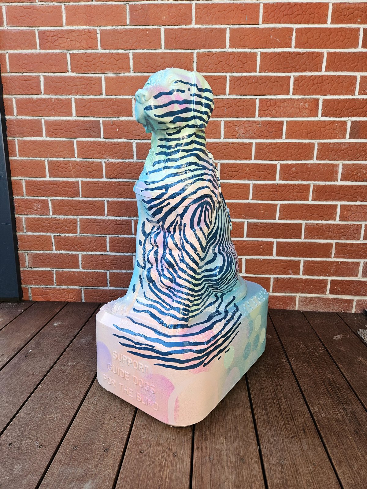 Louis Braille sculpture — finished design viewed from a similar angle against the brick wall