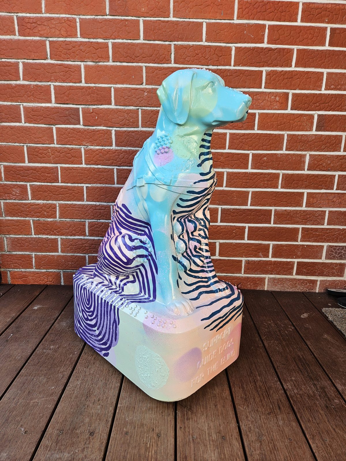 Louis Braille sculpture — finished design viewed front-on against the brick wall