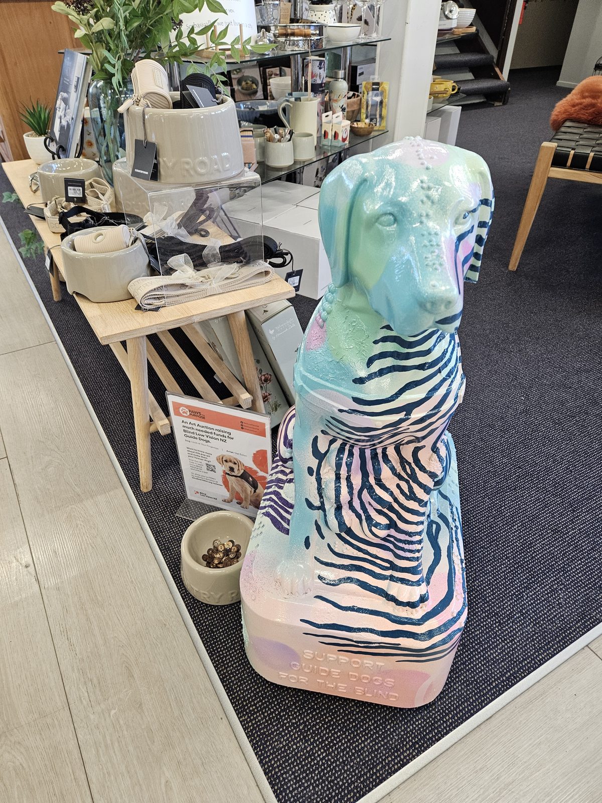 Louis Braille sculpture on display near shelving inside the store