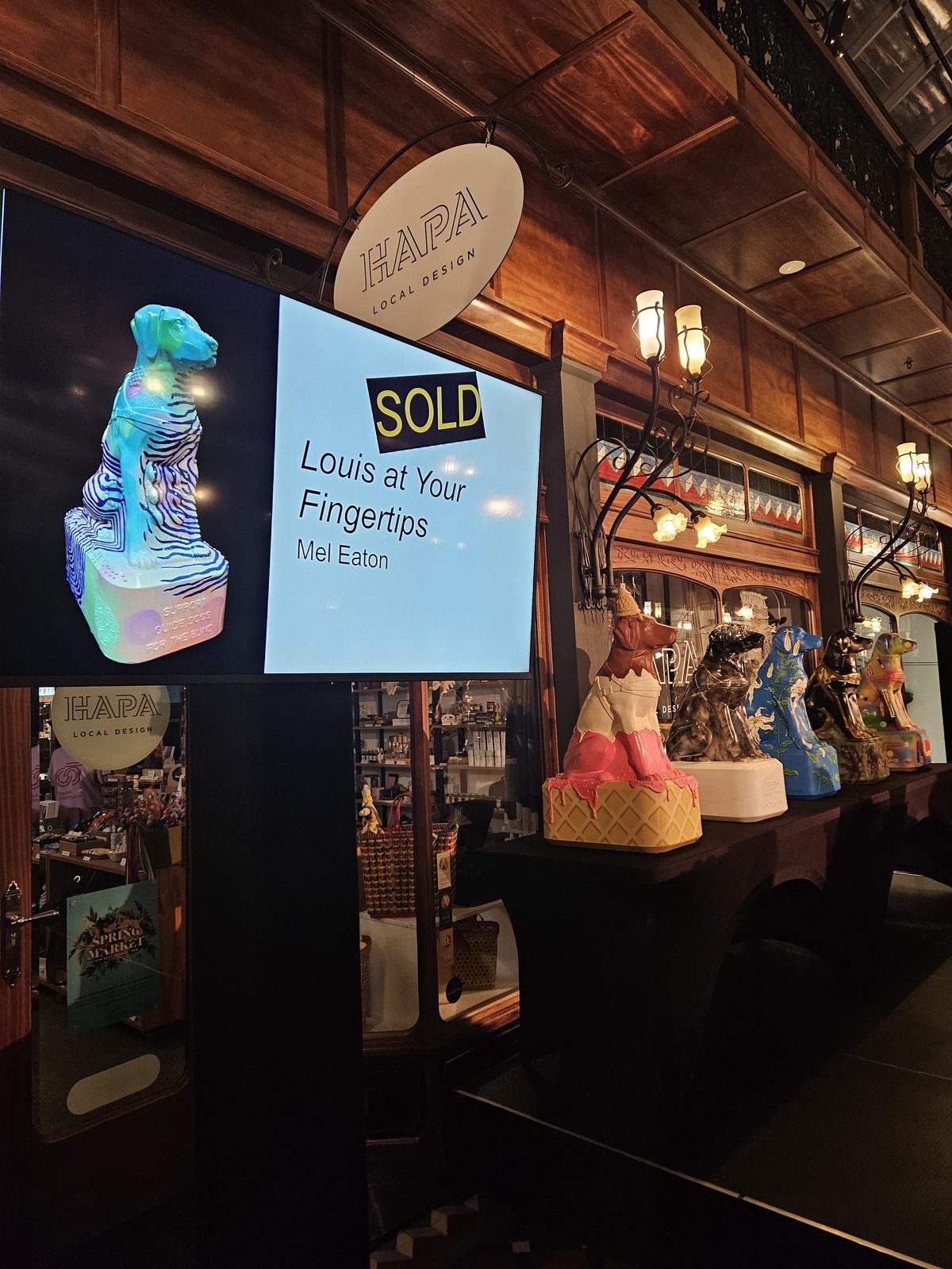 Louis Braille sculpture on display indoors with signage nearby