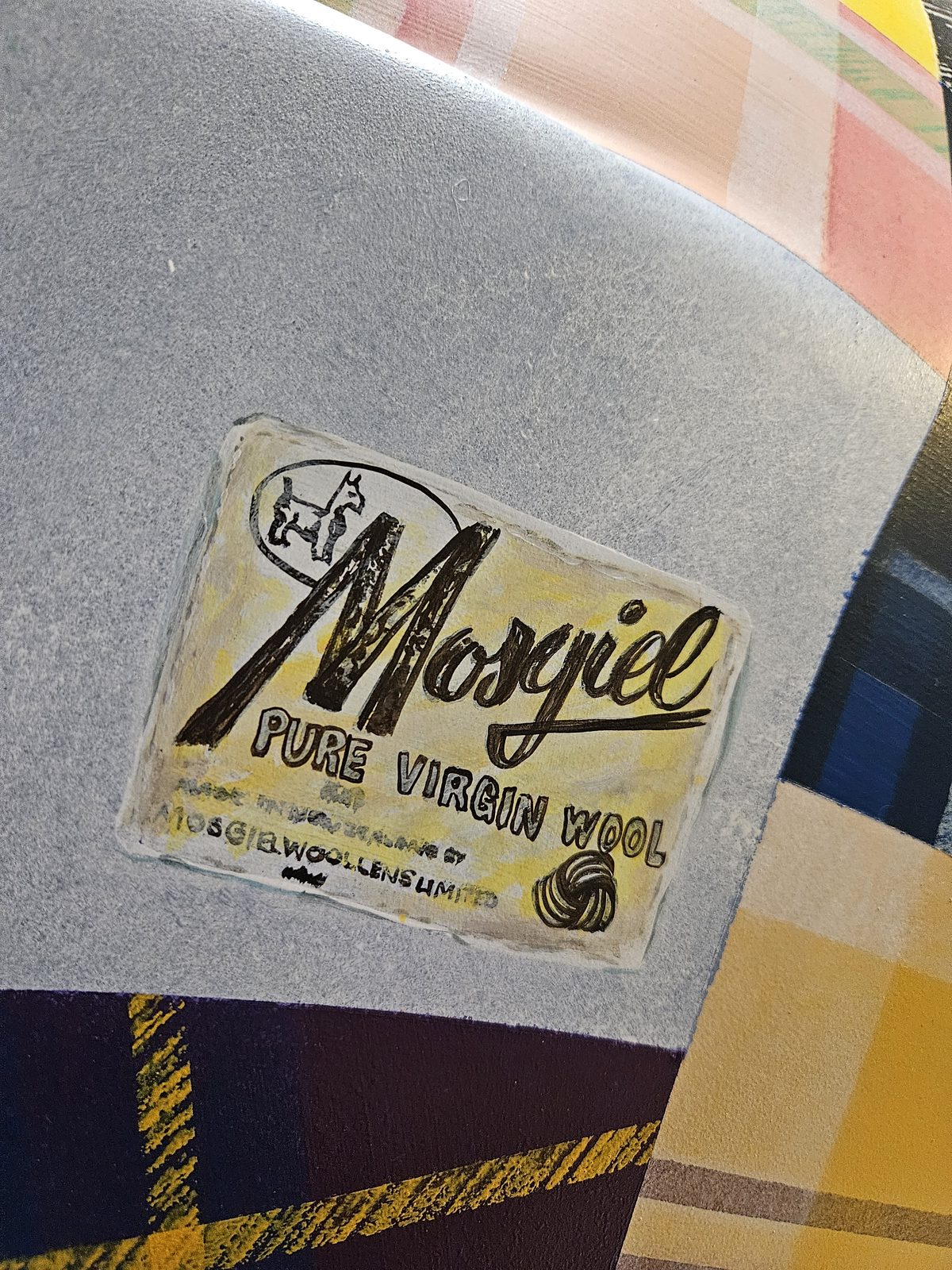 Mammoth Wolley sculpture detail — close-up of a Mosgiel wool label on the patchwork