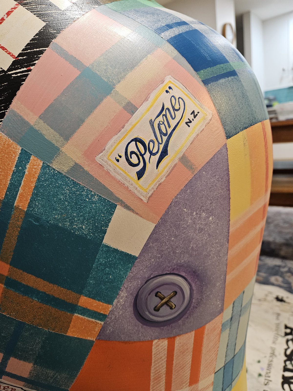 Mammoth Wolley sculpture detail — close-up of a further wool mill label on the patchwork
