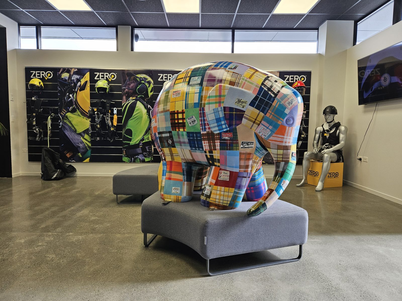 Mammoth Wolley sculpture on display indoors among other Elmer trail sculptures