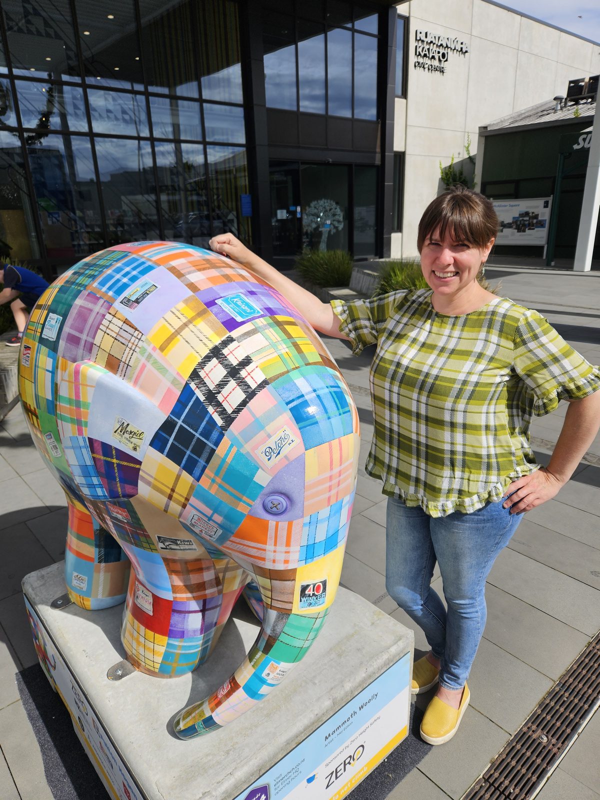 Mammoth Wolley sculpture — Mel standing beside the finished sculpture outdoors