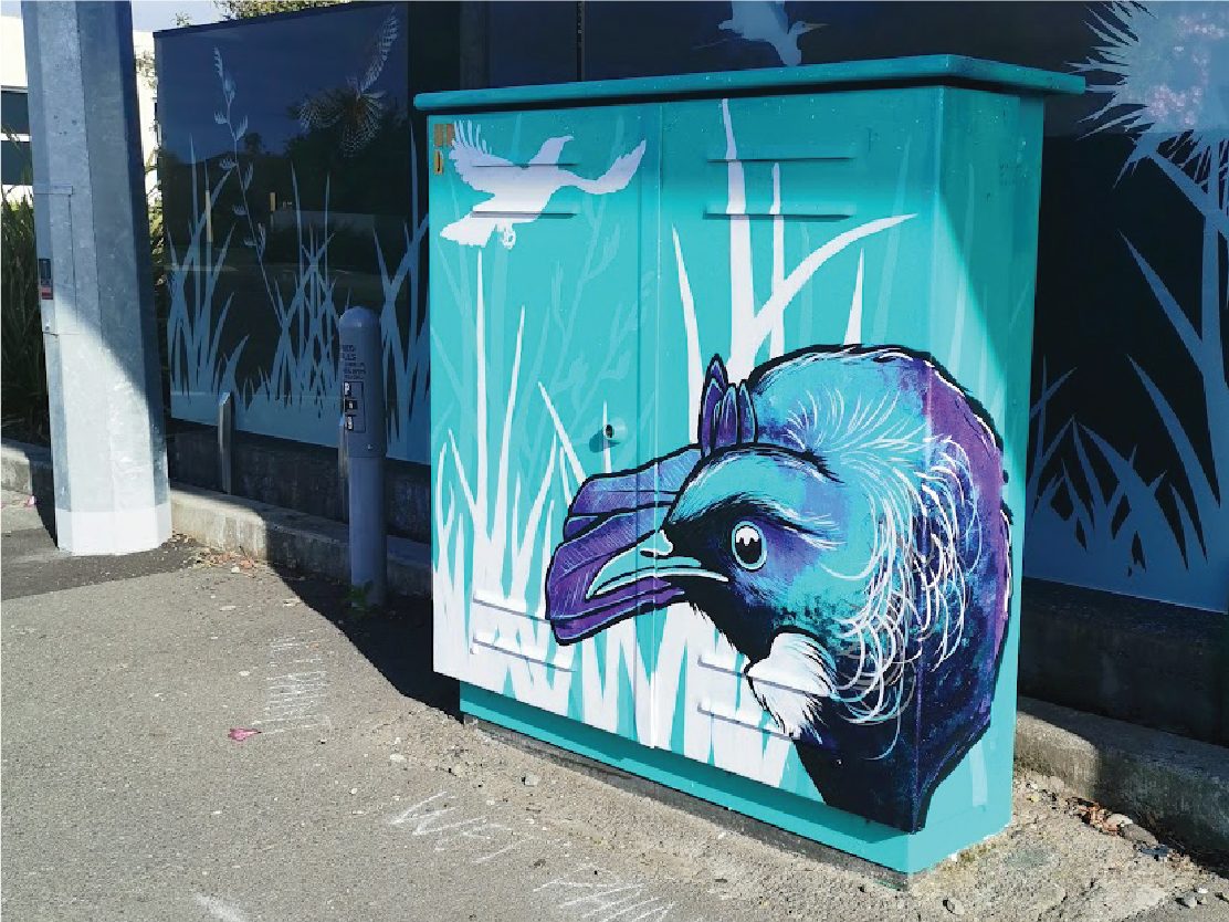 Tui Song mural — close-up of the finished tui design on the teal cabinet