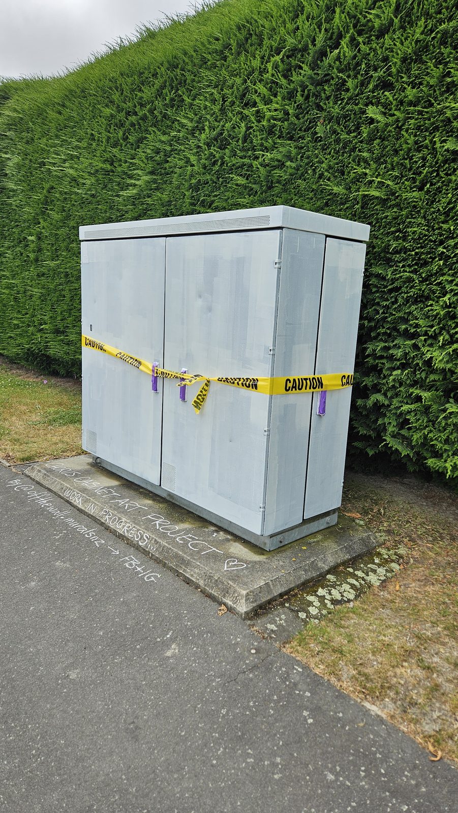 Urban Oasis — cabinet taped up and primed white, ready for painting