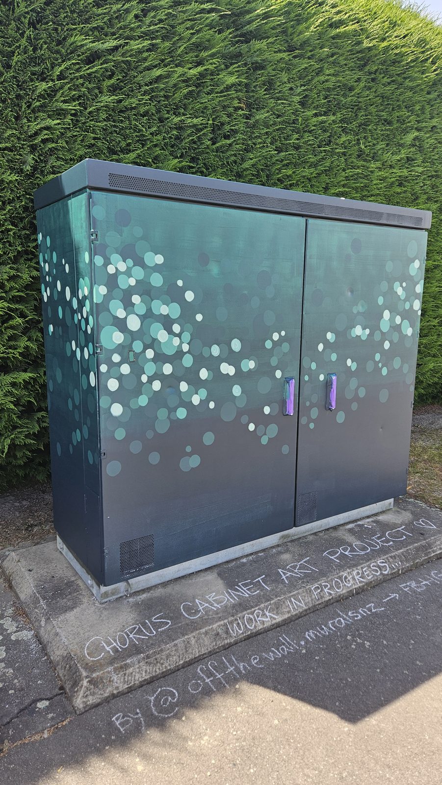 Urban Oasis mural in progress — dark teal base coat with bubble pattern beginning