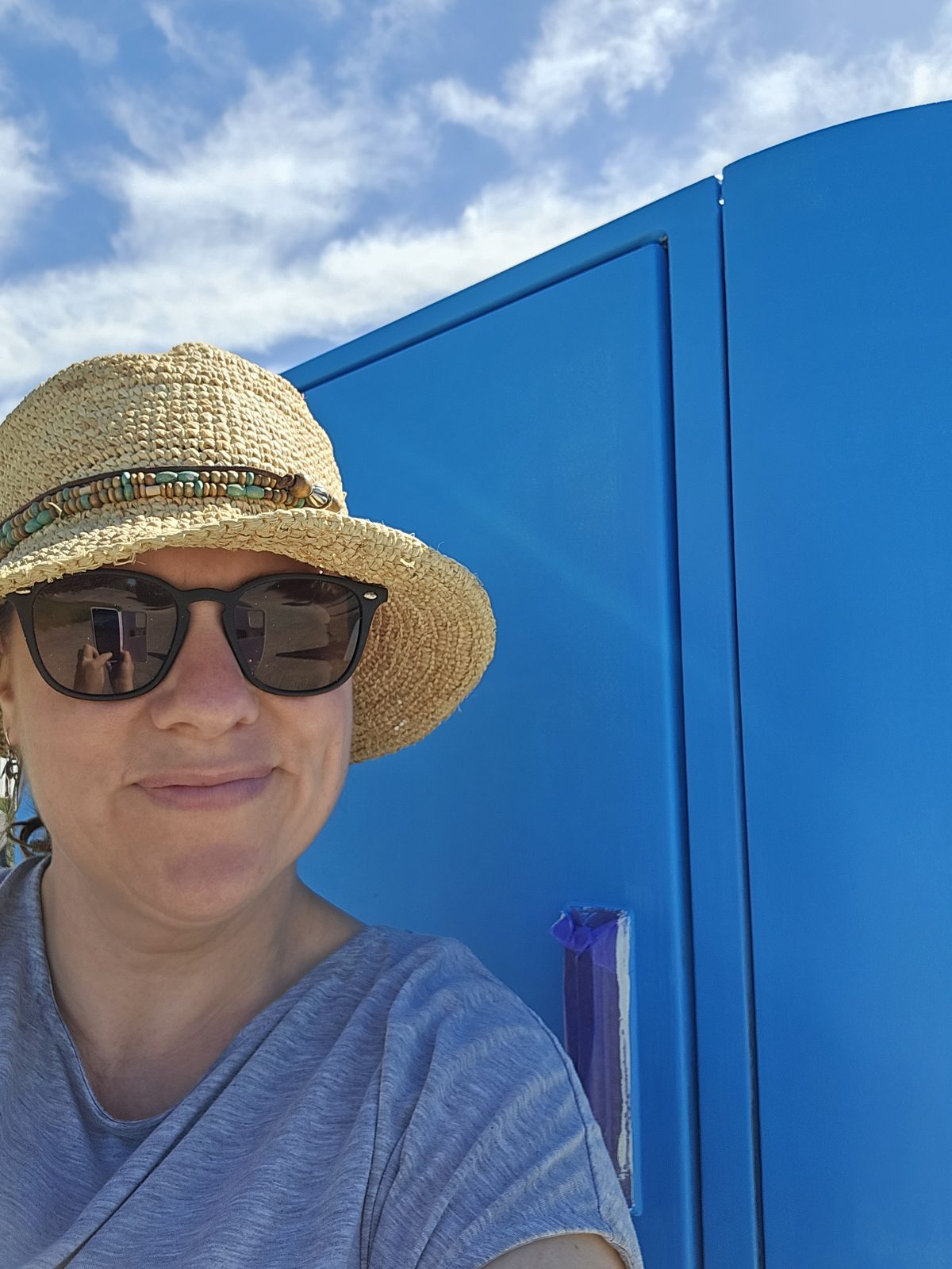 Woven History — Mel beside the cabinet in the early blue base coat stage