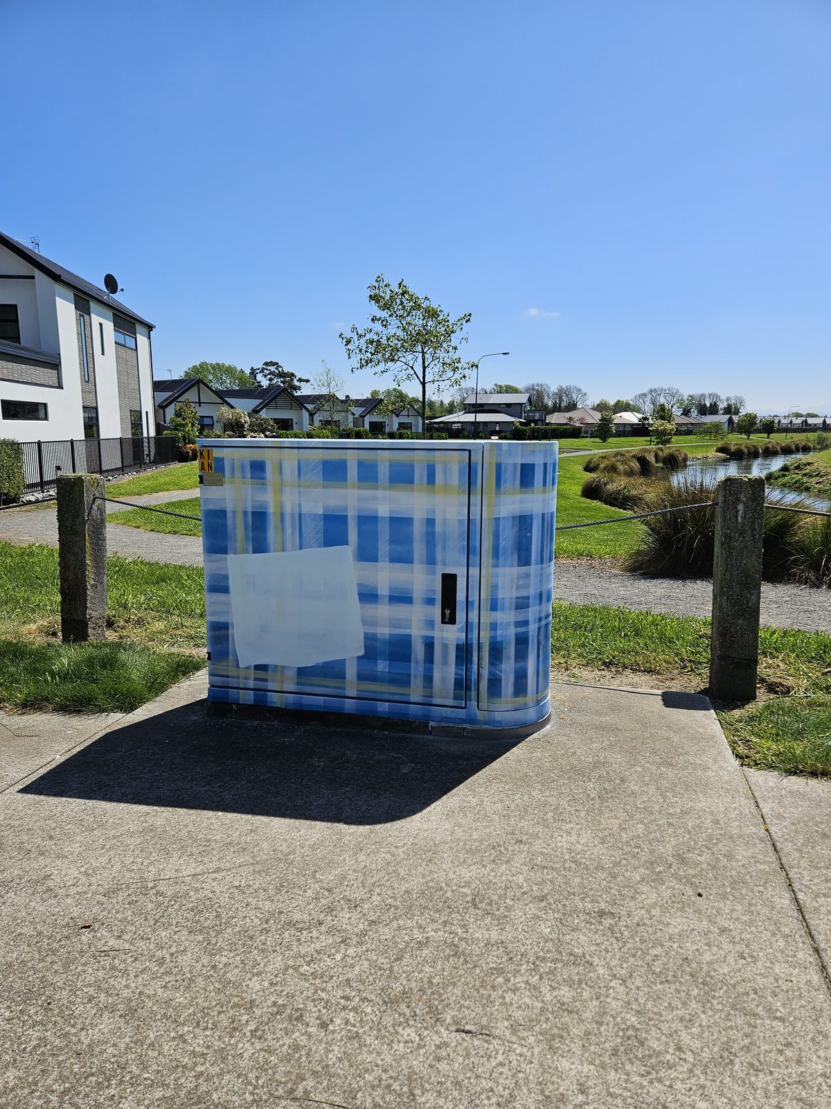 Woven History mural — wide view of the finished cabinet along the footpath