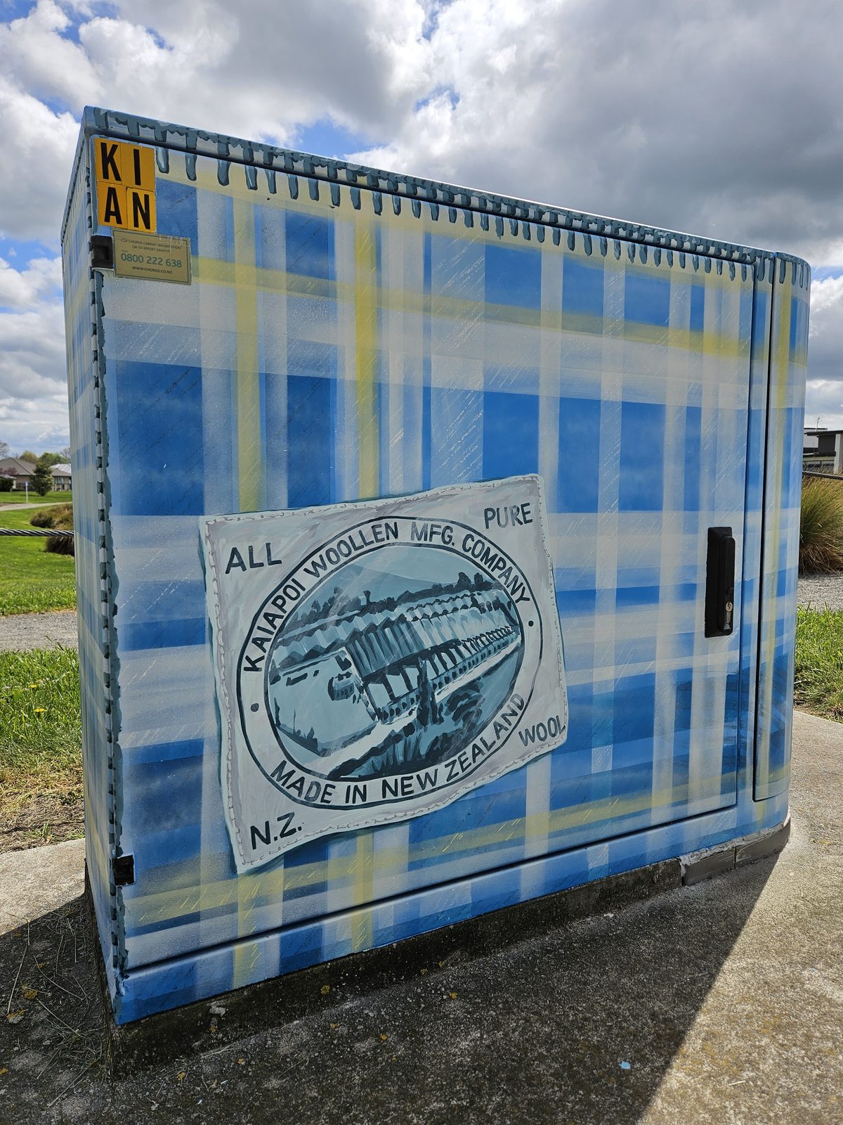 Woven History mural — closer view of the cabinet with the wool mill label sticker